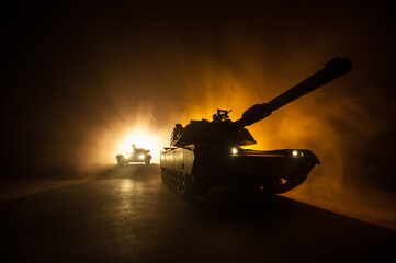 Wall Mural - War Concept. Armored vehicle silhouette fighting scene on war foggy sky background at night. American tank ready to fight.