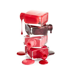 Wall Mural - Stack of bottles with spilled nail polish isolated on white background