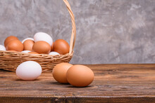 Fresh Organic Farm Eggs Are Placed On The Table And Placed In A Basket On The Kitchen Wooden Table.