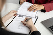© kamiphotos - The job applicant is checking the resume with the Human Resources Department before taking the job interview with the department manager who has submitted the application. Job application ideas.