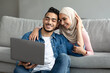 © Prostock-studio - Happy middle-eastern couple searching new furniture for home on Internet