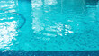 © nieriss - Swimming pool water surface with blue mosaic tiles. Beautiful background with texture of pool water with copy space. Nobody is in the pool. Photo collage blank.