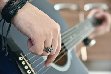 Guitarist playing on acoustic guitar.