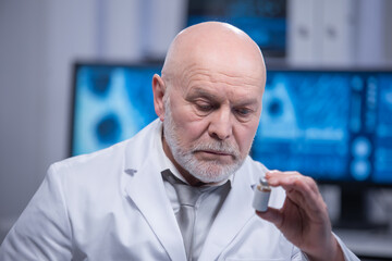 Wall Mural - Elderly professor is doing a science experiment in a modern laboratory. Genetic engineers workplace. The concept of science, medicine and vaccine development.