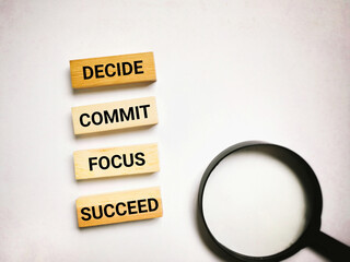 Wall Mural - Inspirational and Motivational Concept - decide commit focus succeed text background.