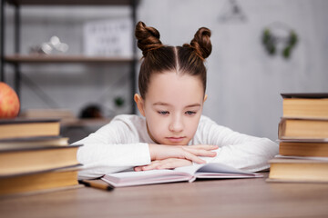 Wall Mural - school, homework and education concept - bored or tired cute school girl with heap of books doing homework at home