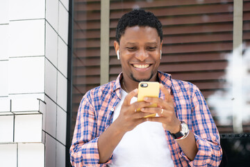 African american man using his phone on the street.