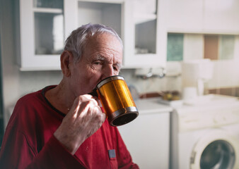 Wall Mural - Old man drinking tea at home