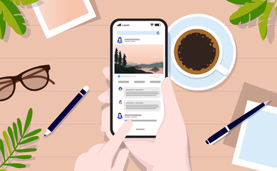 Fototapete - Using social media at home office - Hand holding phone and checking SOME with table in background. Top view. Editable vector illustration mockup.