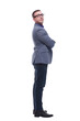 © ASDF - Side view of confident businessman with arms folded against white background