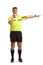 Full Length Portrait Of A Football Referee Blowing A Whistle And Pointing With Finger
