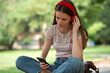 Teenager listening music in a park