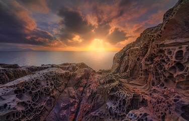 Wall Mural - Sea at sunset and rocks eroded. Populonia, Buca delle Fate. Piombino, Maremma Tuscany, Italy.