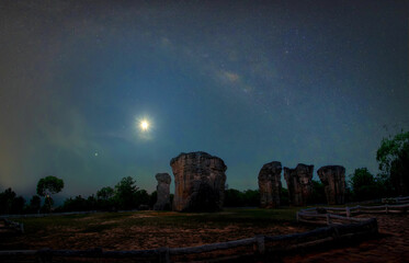 Wall Mural - milky way galaxy and the moon on mor hin khao chaiyaphum thailand, long exposure photograph, with gr