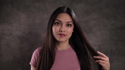 Wall Mural - Portrait of a young beautiful woman against a neutral background - studio shooting