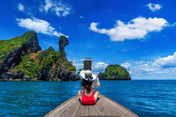 Wall Mural - Beautiful girl in red bikini on boat at Koh Kai island, Thailand.