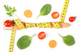 © ratmaner - Wooden fork wrapped in tape measure and fresh ripe vegetables, concept of slimming
