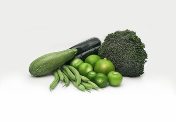 variety of organic green vegetables on white background zucchini, broccoli, green beans, lemons, gre