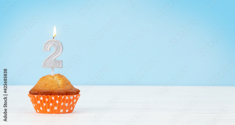 Birthday cupcake with burning candle - obrazy, fototapety, plakaty 