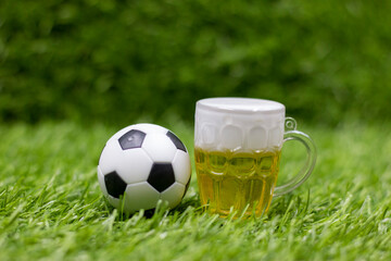 Wall Mural - Soccer ball for Cheers and Beers are on green grass