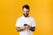 © Drobot Dean - Happy mid aged brunette bearded man holding mobile phone