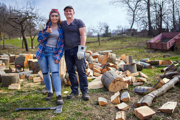 Canvas Print - Farmers couple in the backyard splitting wood