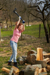 Wall Mural - Woman farmer splitting wood