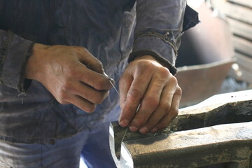 Worker's hands measuring straightness of the railway with a string