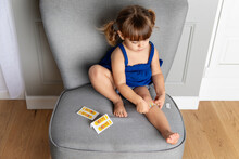 Cute Toddler Girl Putting Band-aid On Leg