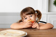 © Lisa Tichané - Portrait of cute toddler girl eating an apple