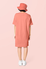 Poster - Woman in peach t-shirt dress and bucket hat casual wear apparel