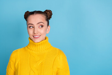 Wall Mural - Photo of adorable young girl beaming smile look empty space wear sweater isolated on blue color background