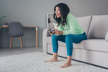 Poster - Full body profile side photo of young excited black girl happy smile play video game joystick console sit couch home