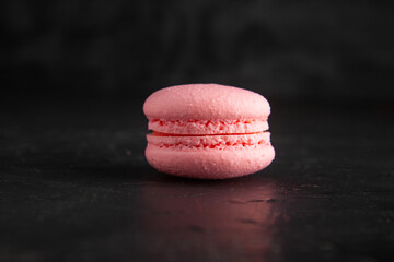 Wall Mural - colored fresh macarons in studio on black background