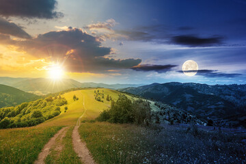 day and night time change concept above road through meadow in mountains. beautiful rural landscape of carpathians with sun and moon. wonderful summer weather with fluffy clouds on the sky