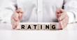 © Cagkan - Businessman hand covers the wooden cubes with the word rating.