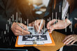 © Nuttapong punna - Business documents on office table with smart phone and calculator digital tablet and graph