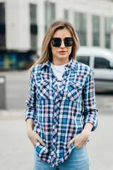 Canvas Print - Fashion portrait of beautiful woman with beautiful face, wearing grunge plaid shirt. Posing alone.