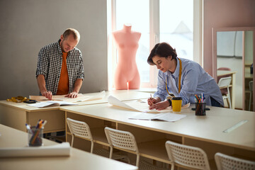 Wall Mural - Drawing process in a classroom performed by two tailors