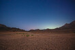 Barren desert landscape in hot climate at night