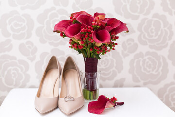 Wall Mural - Wedding accessories: Bride's shoes, bouquet and red boutonniere from lily callas