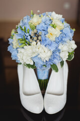 Wall Mural - Wedding accessories in classic blue color: Bride's shoes, rings, boutonniere and wedding bouquet