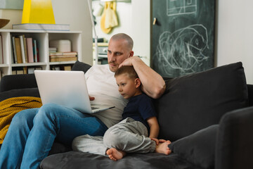 Wall Mural - father and son using laptop computer