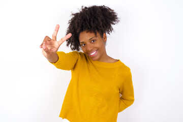 Wall Mural - young beautiful African American woman wearing yellow sweater against white wall directs fingers at camera selects someone. I recommend you. Best choice
