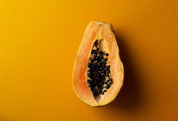 Wall Mural - Sliced fresh and tasty papaya and green lime on a yellow background. Tropical fruit. Copy space.