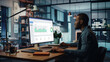 © Gorodenkoff - Handsome Black African American Specialist Working on Desktop Computer in Creative Home Living Room. Freelance Male is Doing Market Analysis and Creates Report with Charts for Clients and Employer.