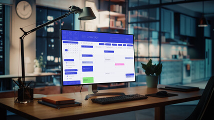 Wall Mural - shot of a desktop computer with openned calendar app standing on the wooden desk in the creative coz