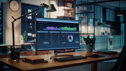 Wall Mural - shot of a desktop computer with financial market analysis application standing on the wooden desk in