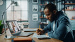 © Gorodenkoff - Handsome African American Man Having a Video Call on Laptop Computer while Sitting Behind Desk in Living Room. Freelancer Working From Home and Talking to Colleagues and Clients Over the Internet.