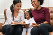 © ronnachaipark - LGBT diversity Lesbian Couple Moments Happiness with her african girl laughing and drawing picture, LGBT lifestyle.